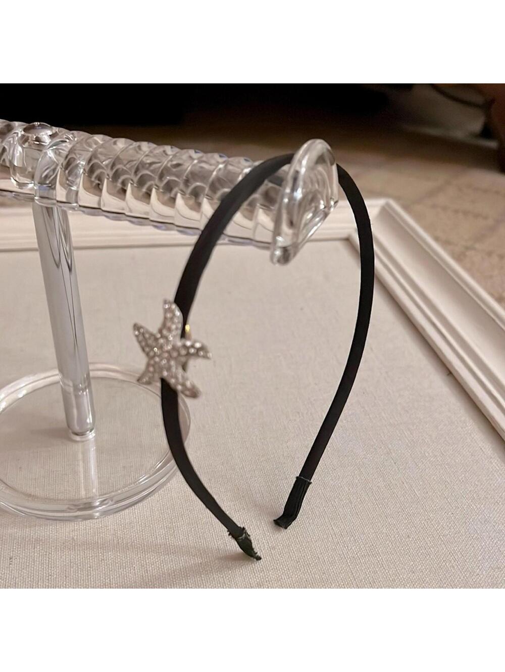 Single row headband w black satin and crystal starfish on side. NWOT